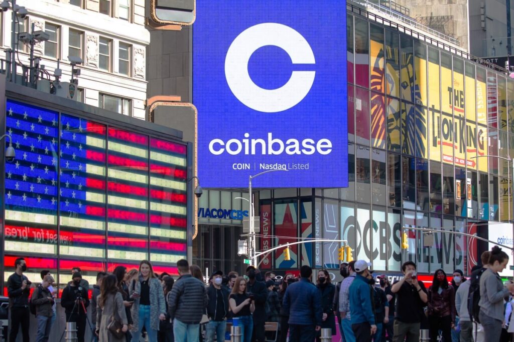 Monitors display Coinbase signage in New York. (Michael Nagle/Bloomberg News)